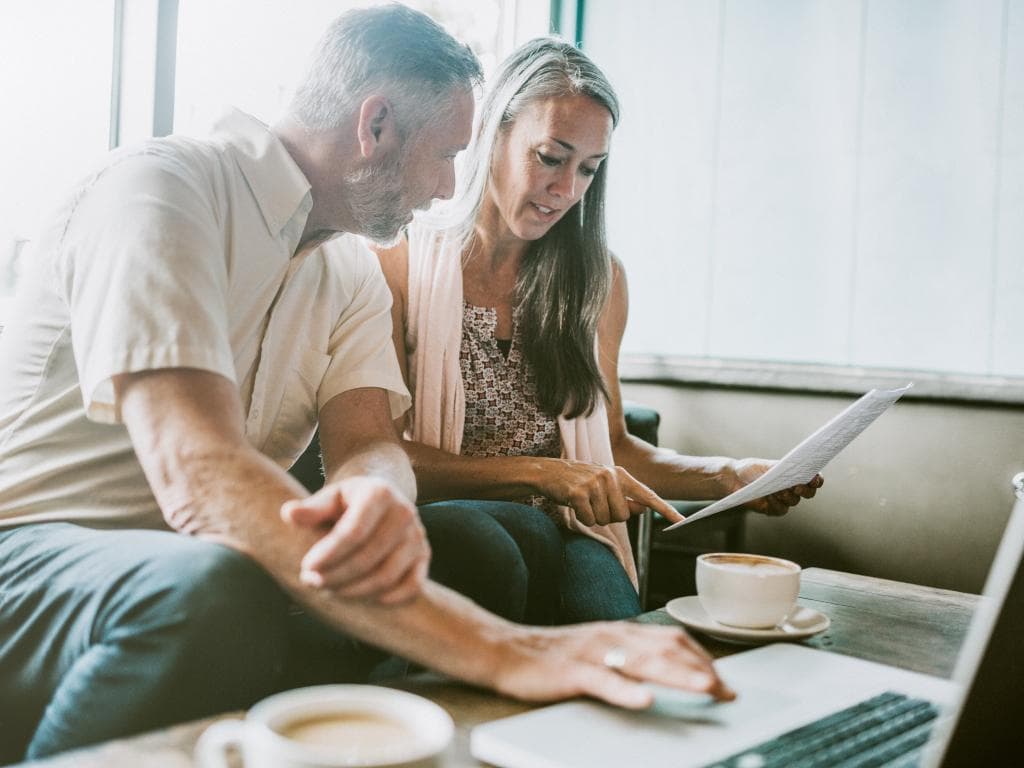 Two people looking at finances L